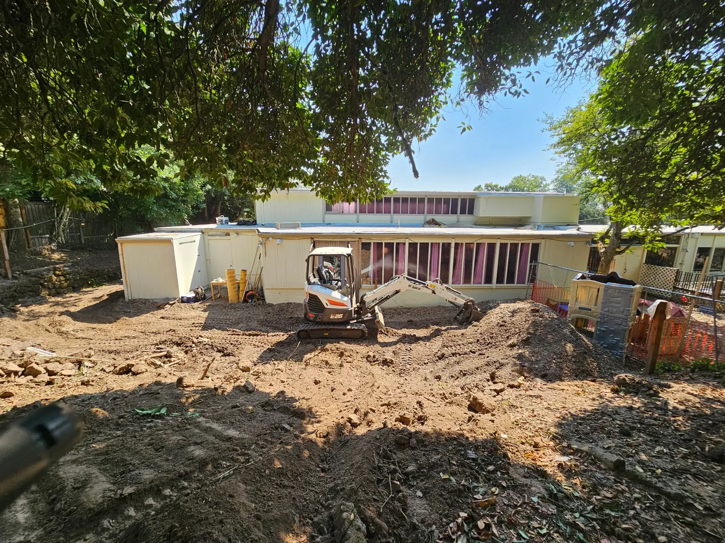 Bobcat excavator working on a sloped residential site